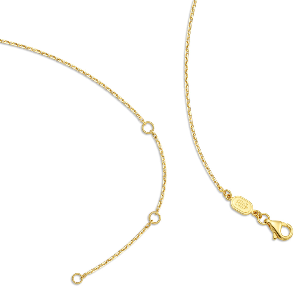Detail view of the J'ENCHANTE 18K gold adjustable chain necklace, showing the extender rings and lobster clasp on a white background.
