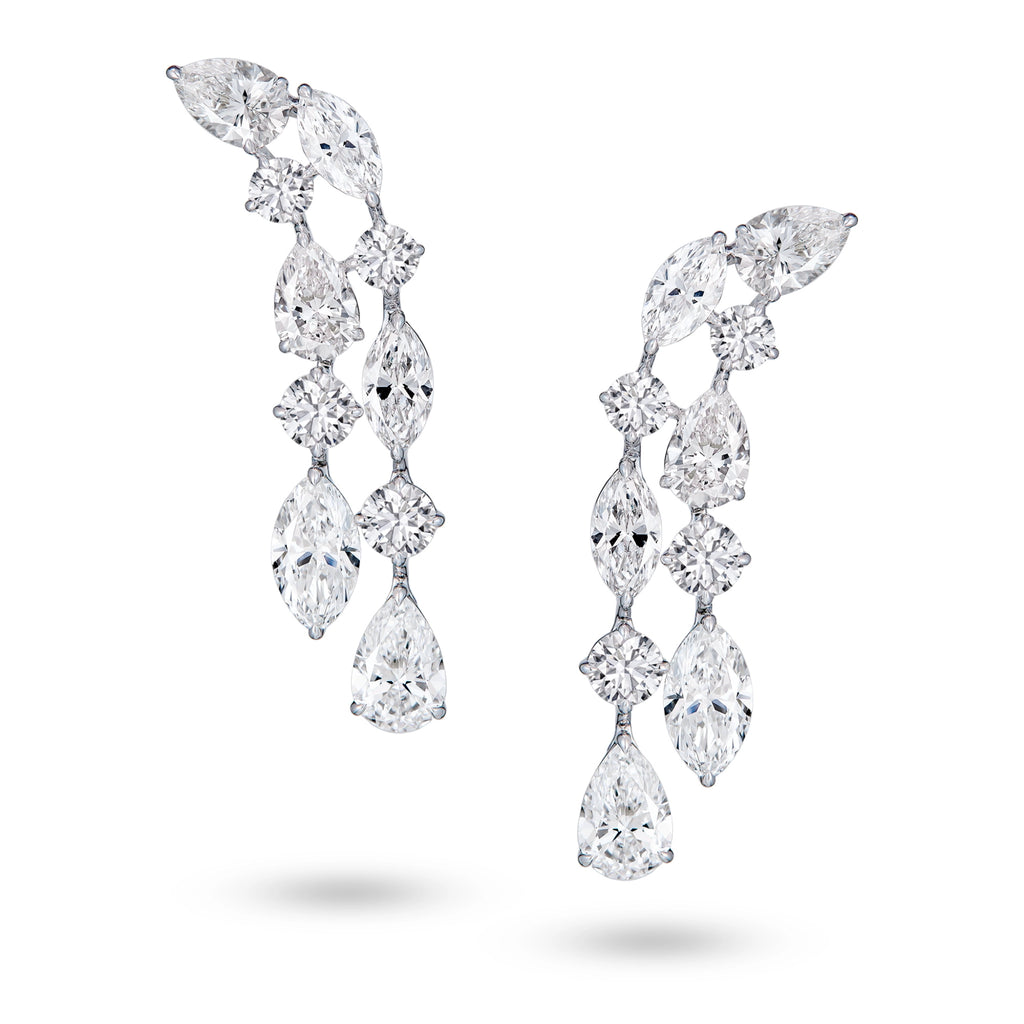 J'ENCHANTE Celeste Cascade earrings in 18K white gold, featuring pear, round and marquise diamonds in a layered drop design, shown as a front-facing pair on a white background.