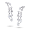 J'ENCHANTE Celeste Cascade earrings in 18K white gold, featuring pear, round and marquise diamonds in a layered drop design, shown as a front-facing pair on a white background.