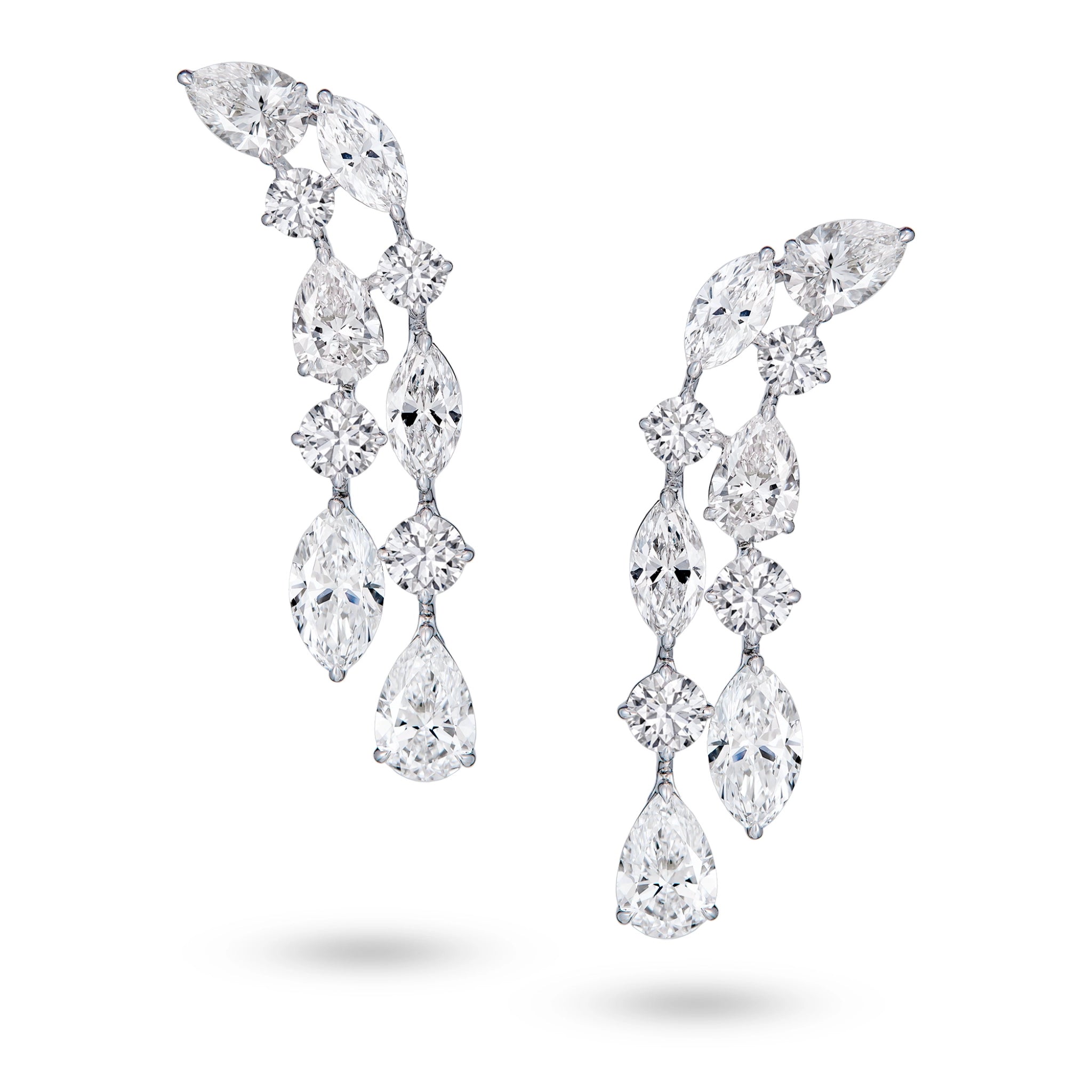 J'ENCHANTE Celeste Cascade earrings in 18K white gold, featuring pear, round and marquise diamonds in a layered drop design, shown as a front-facing pair on a white background.