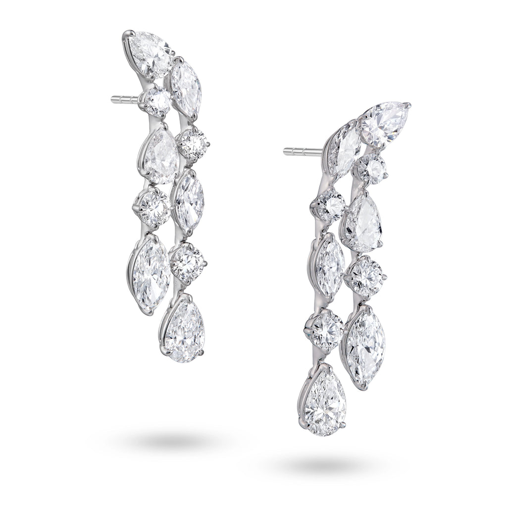Side view of J'ENCHANTE Celeste Cascade 18K white gold diamond earrings, highlighting the pear-shaped drop diamonds, round accents and layered setting structure.