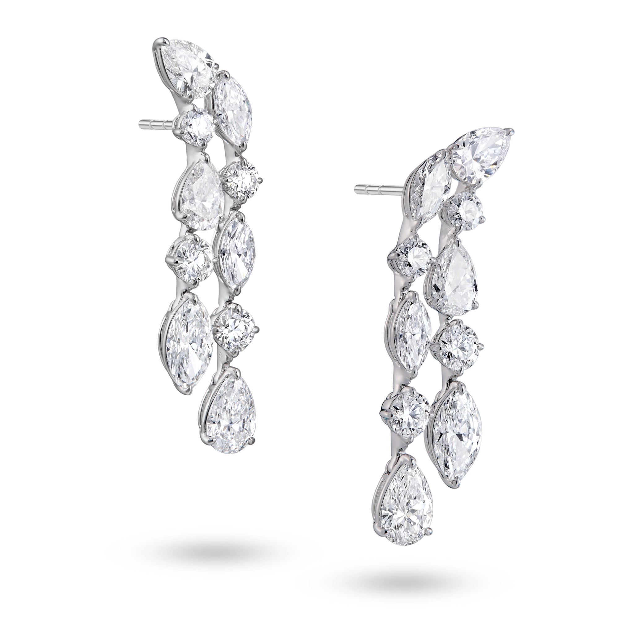 Side view of J'ENCHANTE Celeste Cascade 18K white gold diamond earrings, highlighting the pear-shaped drop diamonds, round accents and layered setting structure.