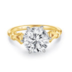 Front detail view of the J'ENCHANTE Intertwine 18K gold lab-grown diamond ring, highlighting the round center diamond and sculptural gold band.