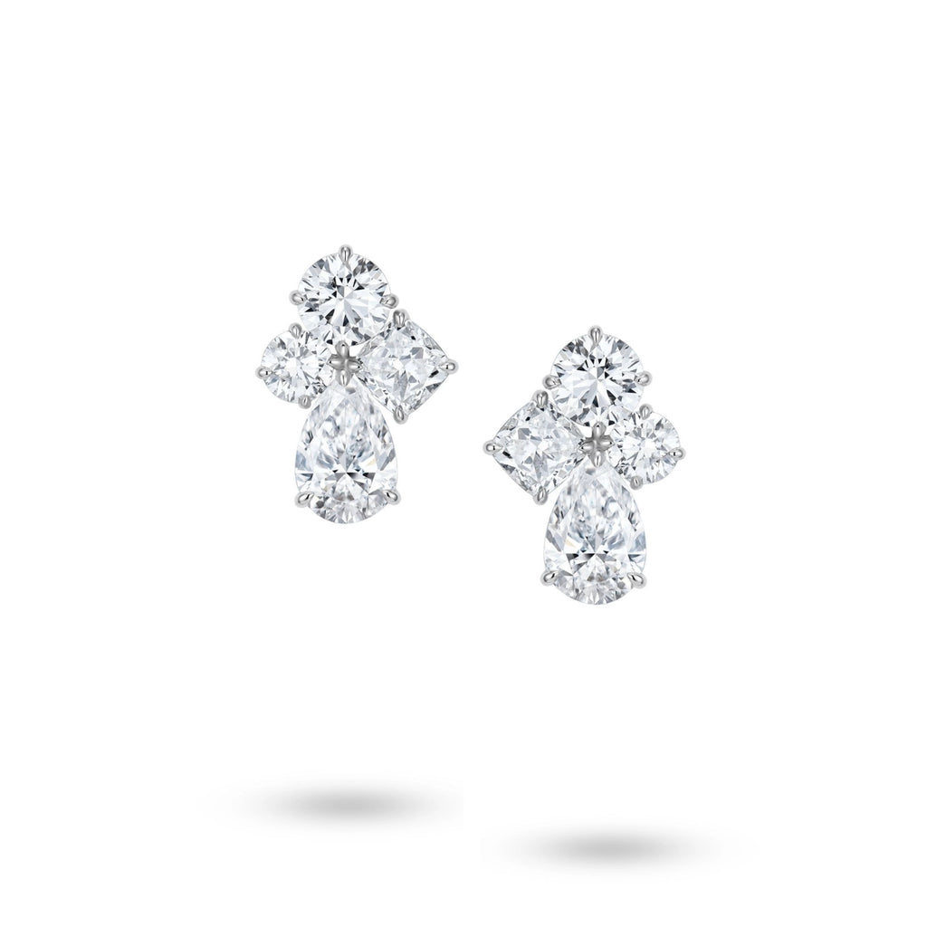 J'ENCHANTE Luminous Poise earrings in 18K white gold, featuring cushion, pear and round diamonds in a floral design, shown as a front-facing pair on a white background.