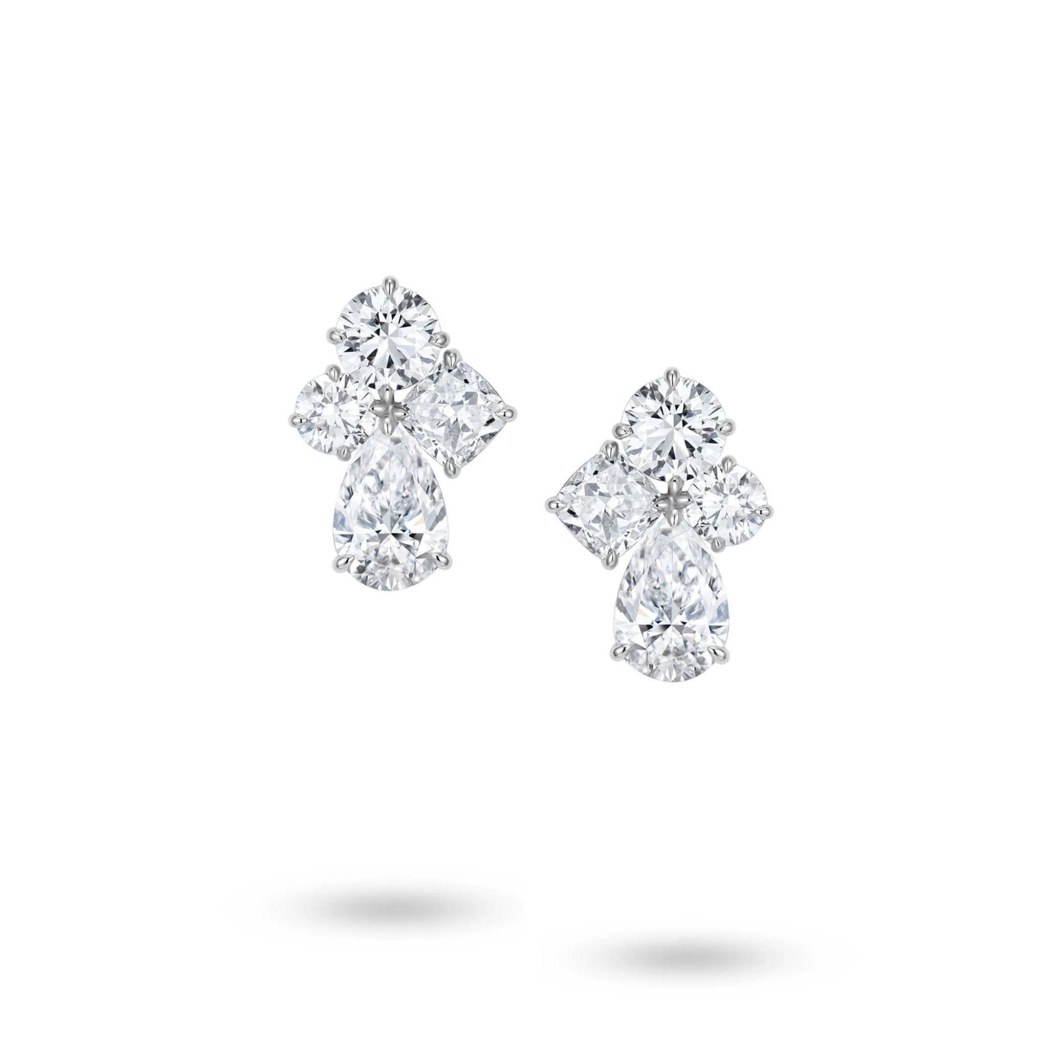 J'ENCHANTE Luminous Poise earrings in 18K white gold, featuring cushion, pear and round diamonds in a floral design, shown as a front-facing pair on a white background.