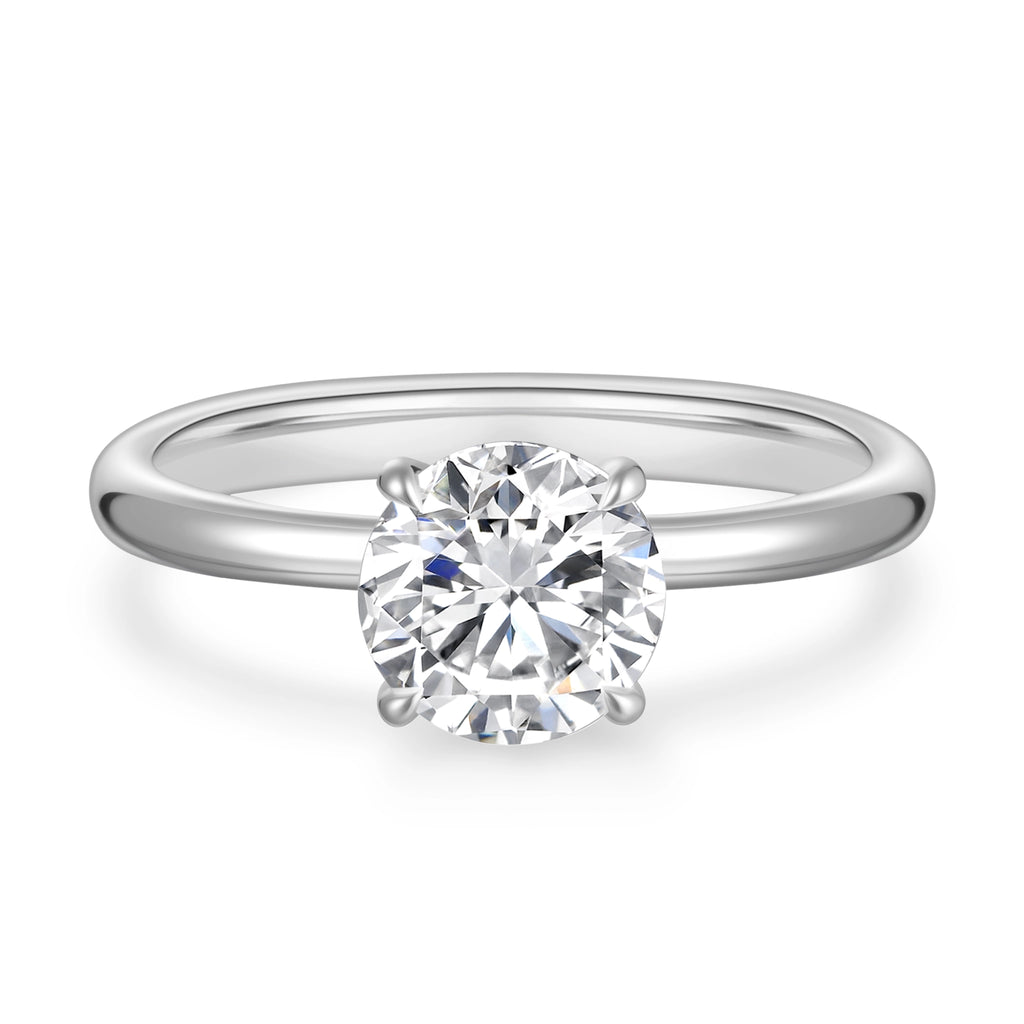 Front detail view of the J'ENCHANTE Petite 18K white gold lab-grown diamond ring, highlighting the round center diamond, four-prong setting and polished band.