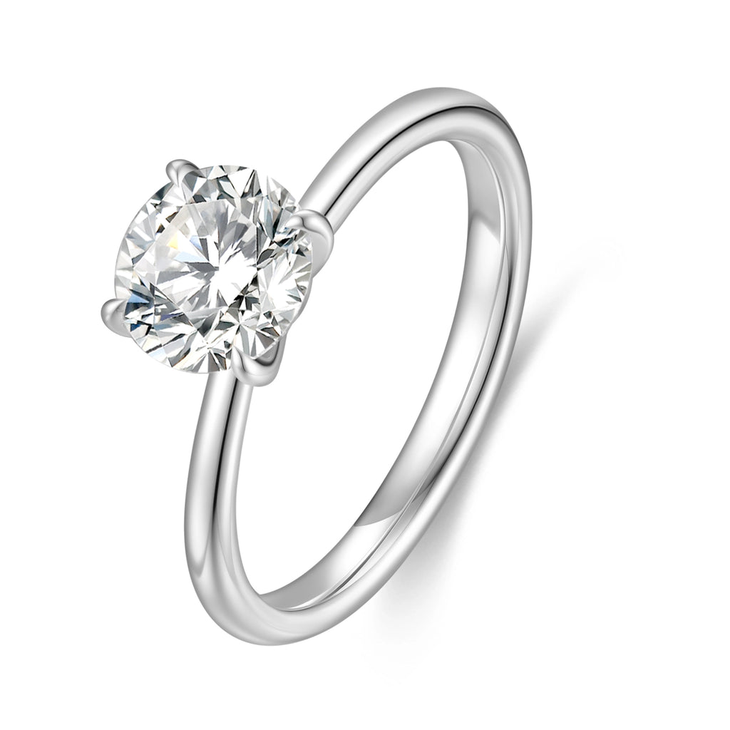 J'ENCHANTE Petite 18K white gold lab-grown diamond solitaire ring, shown on a white background with a round center diamond, four-prong setting and refined band.