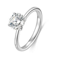 J'ENCHANTE Petite 18K white gold lab-grown diamond solitaire ring, shown on a white background with a round center diamond, four-prong setting and refined band.