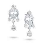 Angled view of the J'ENCHANTE Astral Composition statement diamond earrings. The image highlights the intricate 18K white gold sculptural setting and the dynamic arrangement of mixed-cut stones. This perspective reveals the depth and fluidity of the suspended diamond drops, engineered to capture, refract, and extend light with every subtle movement.