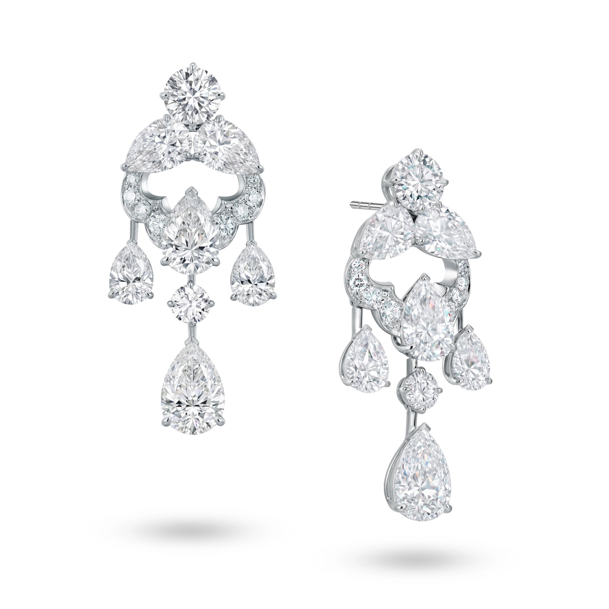 Angled view of the J'ENCHANTE Astral Composition statement diamond earrings. The image highlights the intricate 18K white gold sculptural setting and the dynamic arrangement of mixed-cut stones. This perspective reveals the depth and fluidity of the suspended diamond drops, engineered to capture, refract, and extend light with every subtle movement.