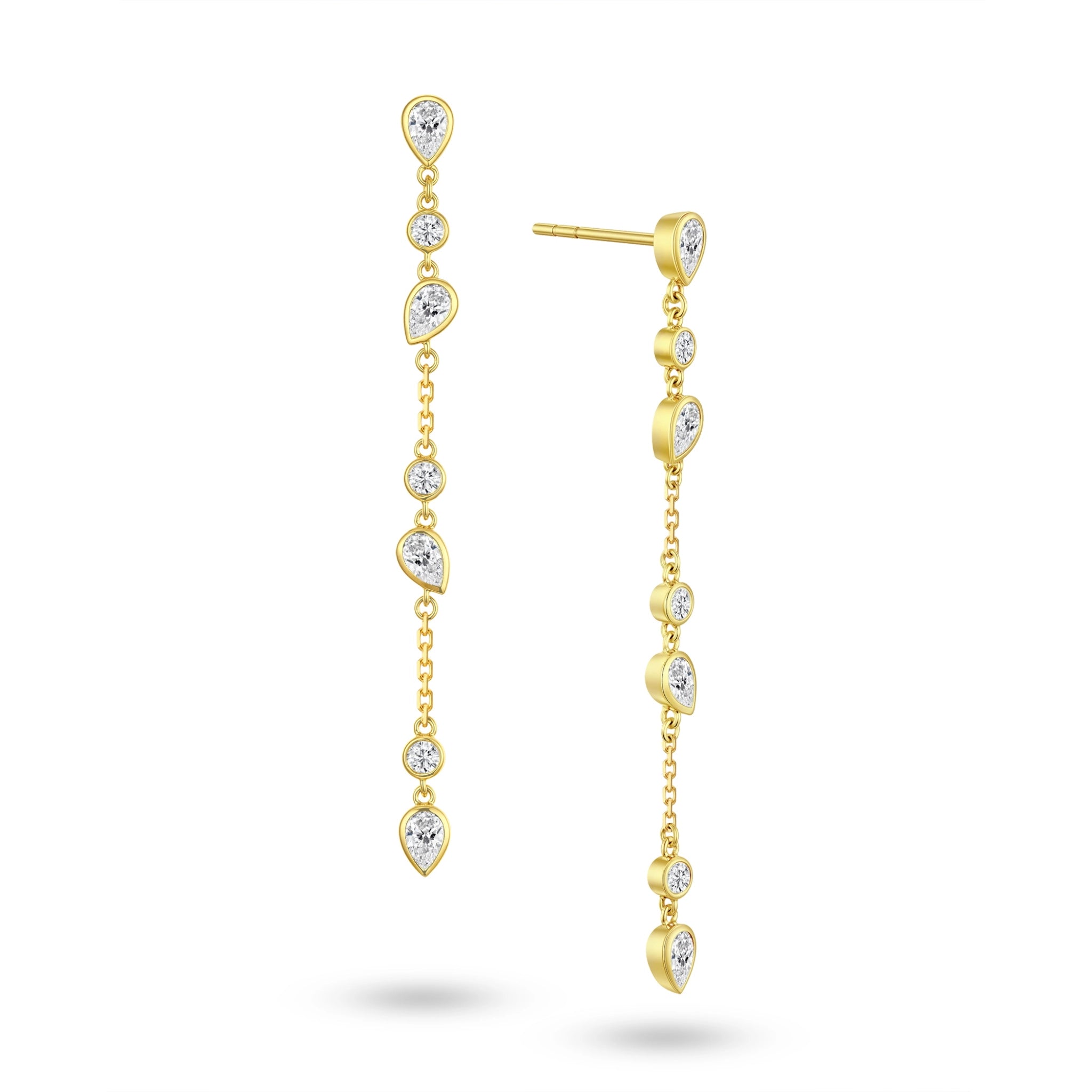 Angled view of the J'ENCHANTE DEW cascading teardrop and round diamond earrings. The image highlights the delicate gold setting and the exquisite layered cascade of 7 alternating diamond cuts. Catching light with every subtle movement, this expressive design adds depth and sophisticated brilliance without overwhelming.
