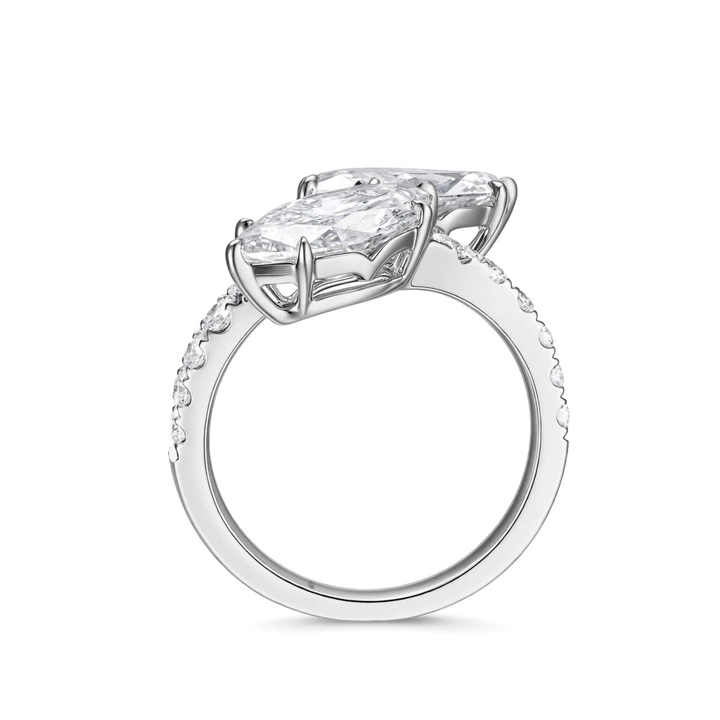 ide profile view of the J'ENCHANTE DUO double stone diamond ring in 18K white gold. Showcasing the secure setting and the open architectural gallery beneath the two 2-carat marquise diamonds. This refined support structure allows maximum light to pass through, dramatically enhancing the clarity and brilliance of the focal stones.