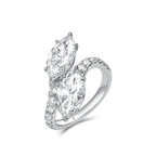 Angled view of the J'ENCHANTE DUO marquise diamond bypass ring. The perspective highlights the sculptural 18K white gold setting and the flowing lines of the pavé-set band. The elevated 2-carat marquise diamonds catch the light brilliantly, emphasizing the ring's striking depth and dynamic movement.