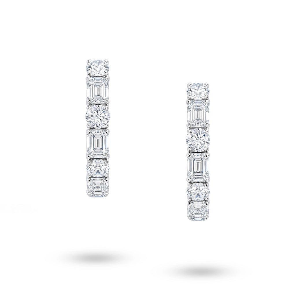 Front view of J'ENCHANTE Facette Rhythm hoop earrings with alternating round and emerald-cut lab-grown diamonds in 18K white gold.