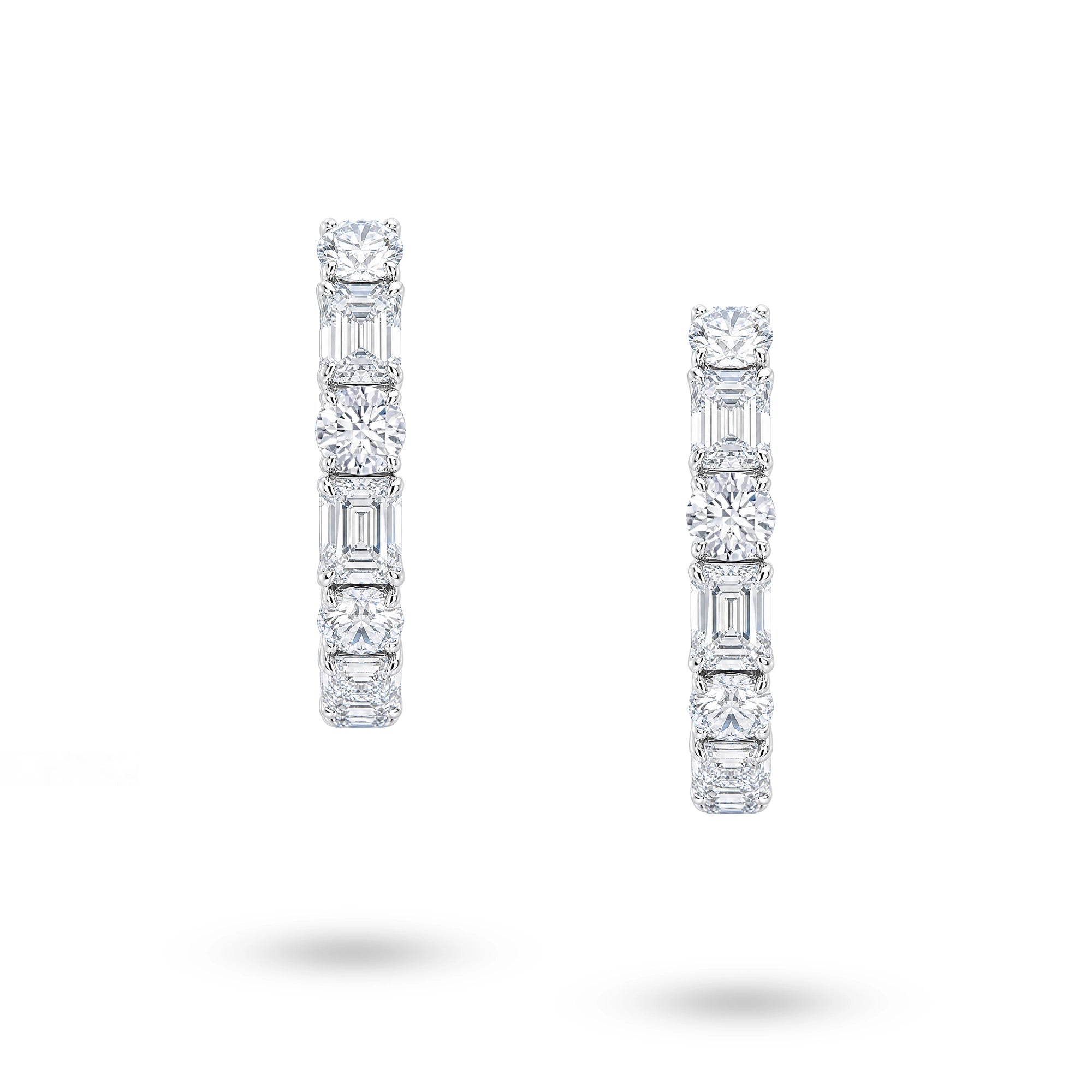Front view of J'ENCHANTE Facette Rhythm hoop earrings with alternating round and emerald-cut lab-grown diamonds in 18K white gold.