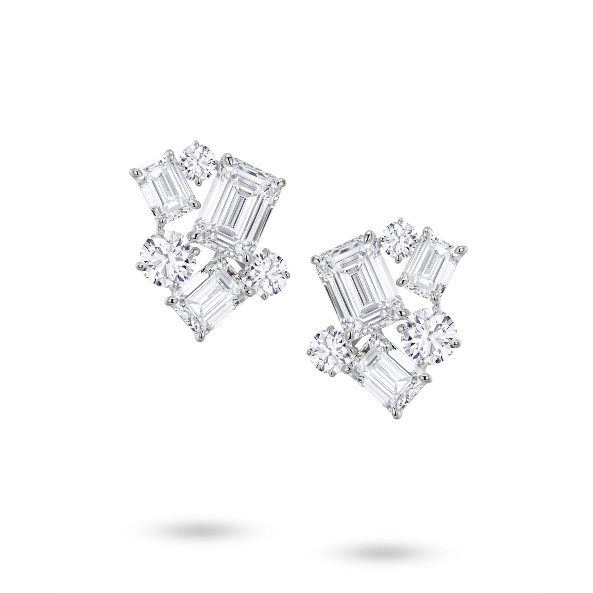 Front view of the J'ENCHANTE The Facette Structure diamond earrings in 18K white gold. Showcasing a bold architectural cluster, each earring is anchored by a 2.0-carat emerald-cut center diamond, surrounded by offset emerald and round brilliant stones (12 diamonds totaling approx. 9.37 carats). This precise geometric composition creates a refined interplay of light, shadow, and striking linear elegance.
