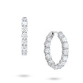 Angled view of the J'ENCHANTE Full Light 4.40ct diamond hoop earrings. The perspective highlights the refined 18K white gold setting and the precise cadence of the 13 round stones per hoop, catching brilliant light and fluid rhythm with every subtle movement.