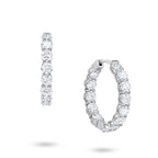 Angled view of the J'ENCHANTE Full Light 4.40ct diamond hoop earrings. The perspective highlights the refined 18K white gold setting and the precise cadence of the 13 round stones per hoop, catching brilliant light and fluid rhythm with every subtle movement.