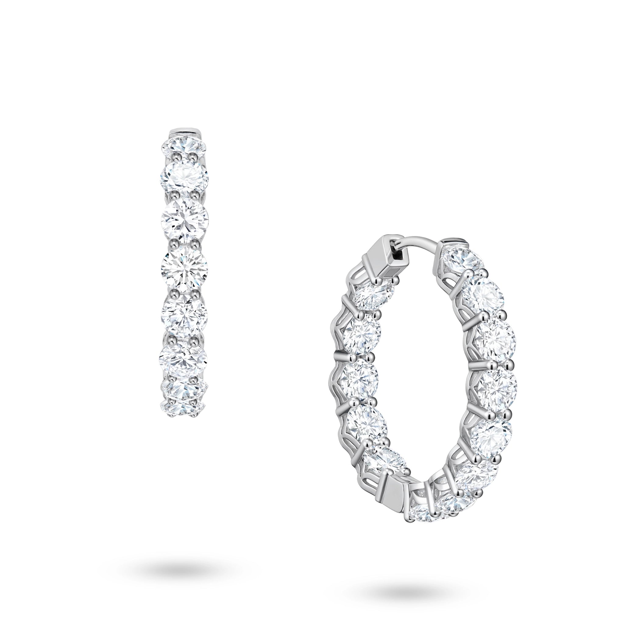 Angled view of the J'ENCHANTE Full Light 4.40ct diamond hoop earrings. The perspective highlights the refined 18K white gold setting and the precise cadence of the 13 round stones per hoop, catching brilliant light and fluid rhythm with every subtle movement.