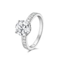 Angled view of the J'ENCHANTE JOY 2-carat pavé diamond ring, showcasing the refined lines of the 18k white gold band adorned with diamonds and the brilliant focal center stone.