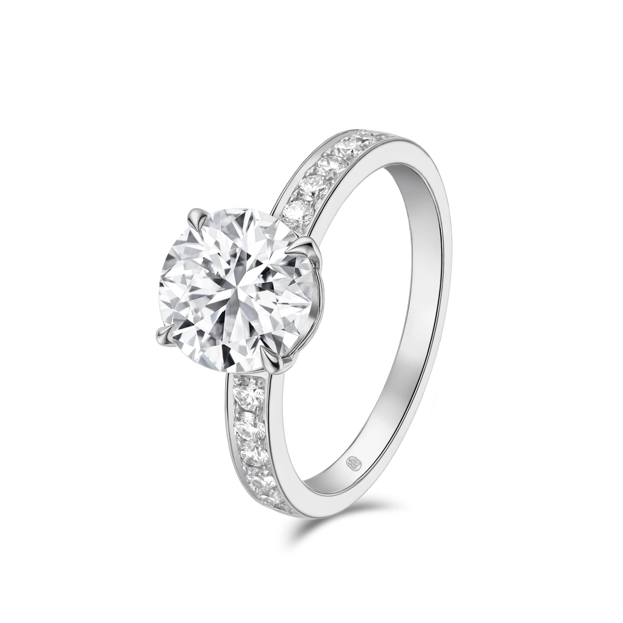Angled view of the J'ENCHANTE JOY 2-carat pavé diamond ring, showcasing the refined lines of the 18k white gold band adorned with diamonds and the brilliant focal center stone.
