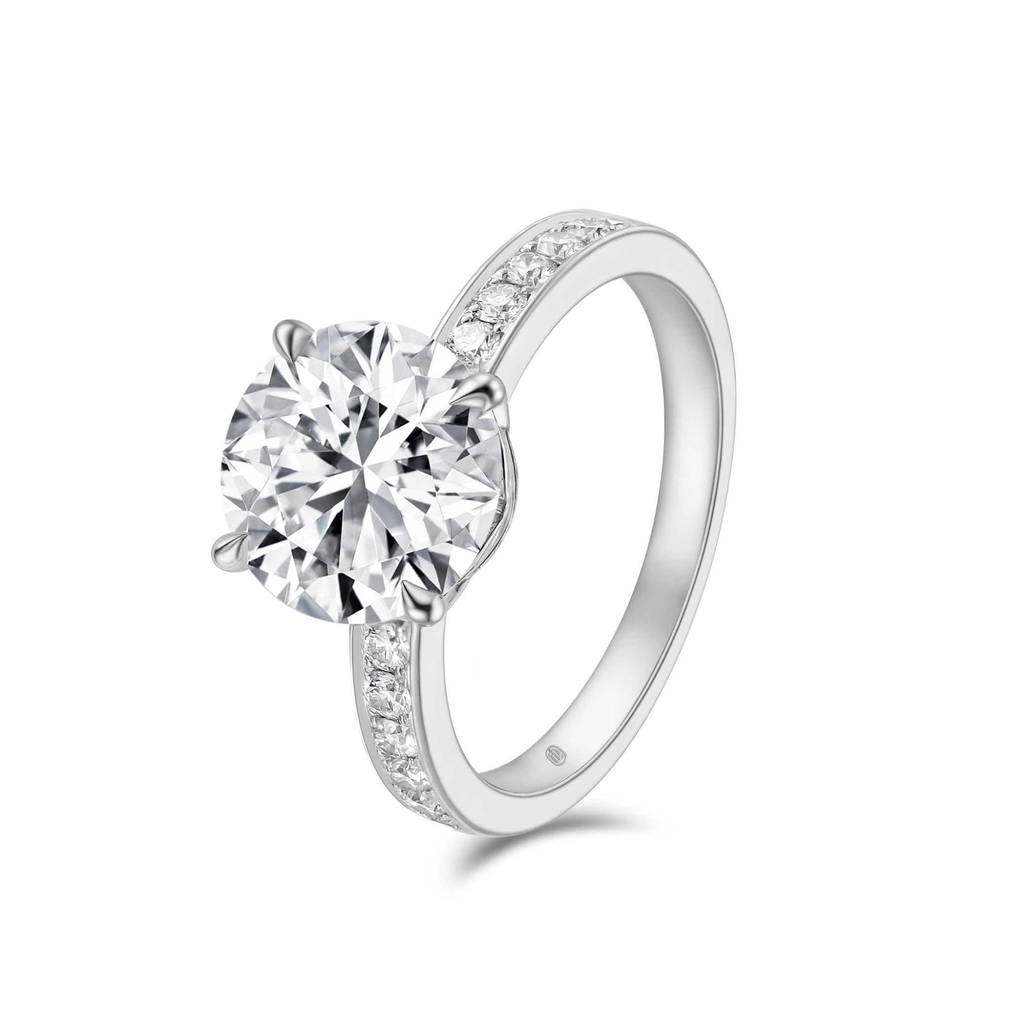 Angled view of the J'ENCHANTE JOY 3-carat pavé band diamond ring, highlighting the spectacular presence of the larger 3-carat center stone paired with the brilliantly detailed 18k white gold pavé band.