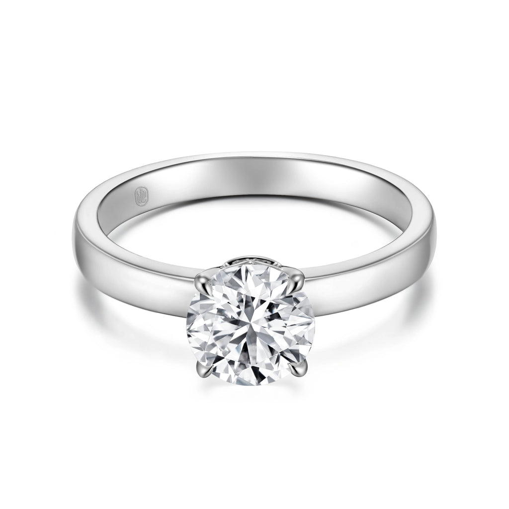Front view of the J'ENCHANTE JOY classic solitaire diamond ring in 18k white gold, featuring the signature J-Setting that gently supports the center stone for refined brilliance and maximum light return.