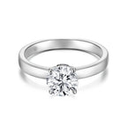 Front view of the J'ENCHANTE JOY classic solitaire diamond ring in 18k white gold, featuring the signature J-Setting that gently supports the center stone for refined brilliance and maximum light return.