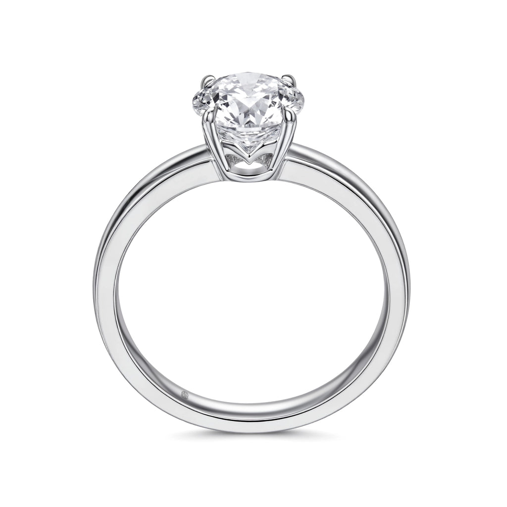 Upright profile view of the J'ENCHANTE JOY classic solitaire diamond ring, displaying the perfect circular band in sleek 18k white gold, the elevated J-Setting structure, and the signature brand hallmark.