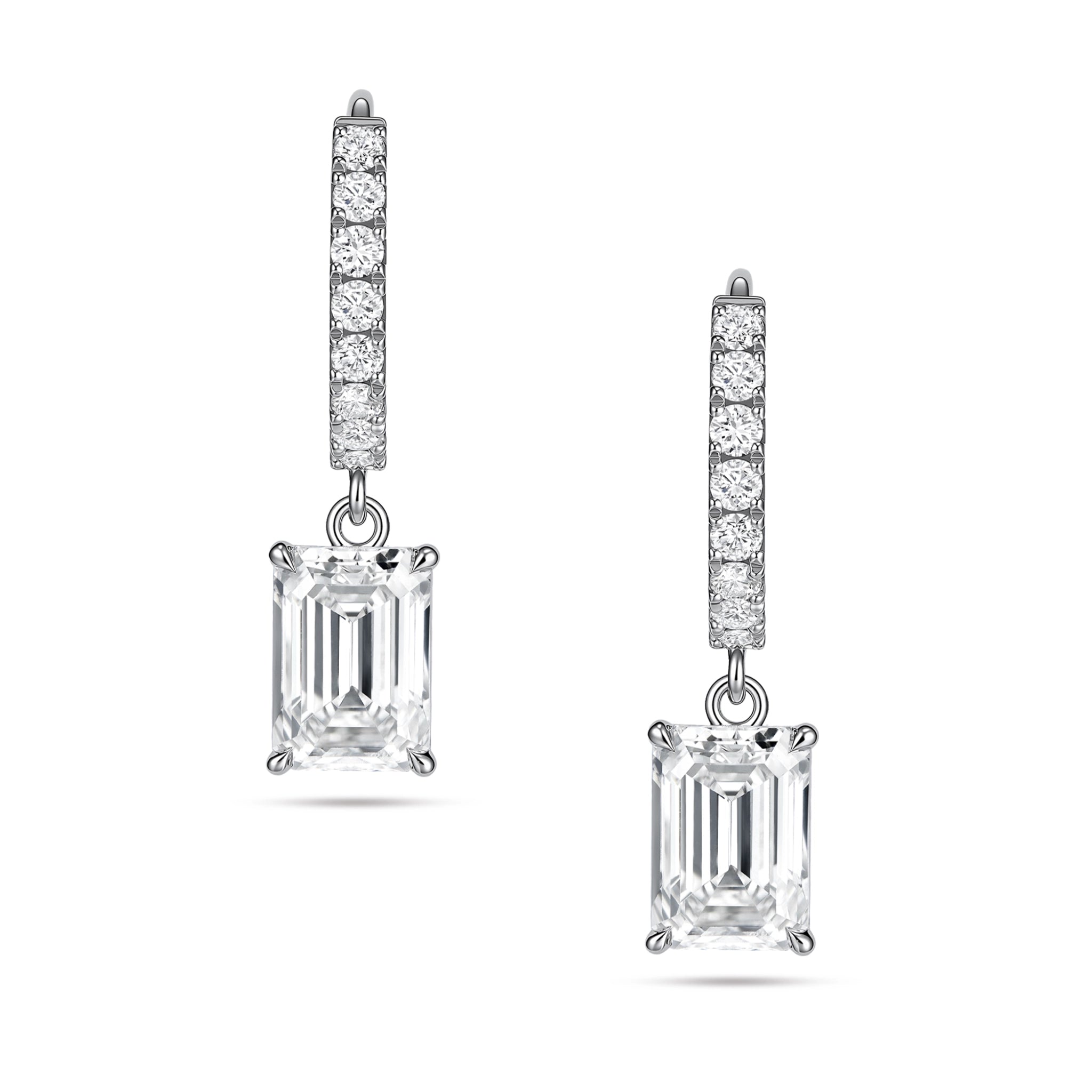 Front view of the J'ENCHANTE JOY emerald drop earrings, featuring a pair of refined 18K white gold hoops adorned with 16 pavé-set diamonds (approx. 0.2 carats). The clean linear hoops create a sophisticated contrast with the clear, architectural silhouette of the suspended emerald-cut focal stones.