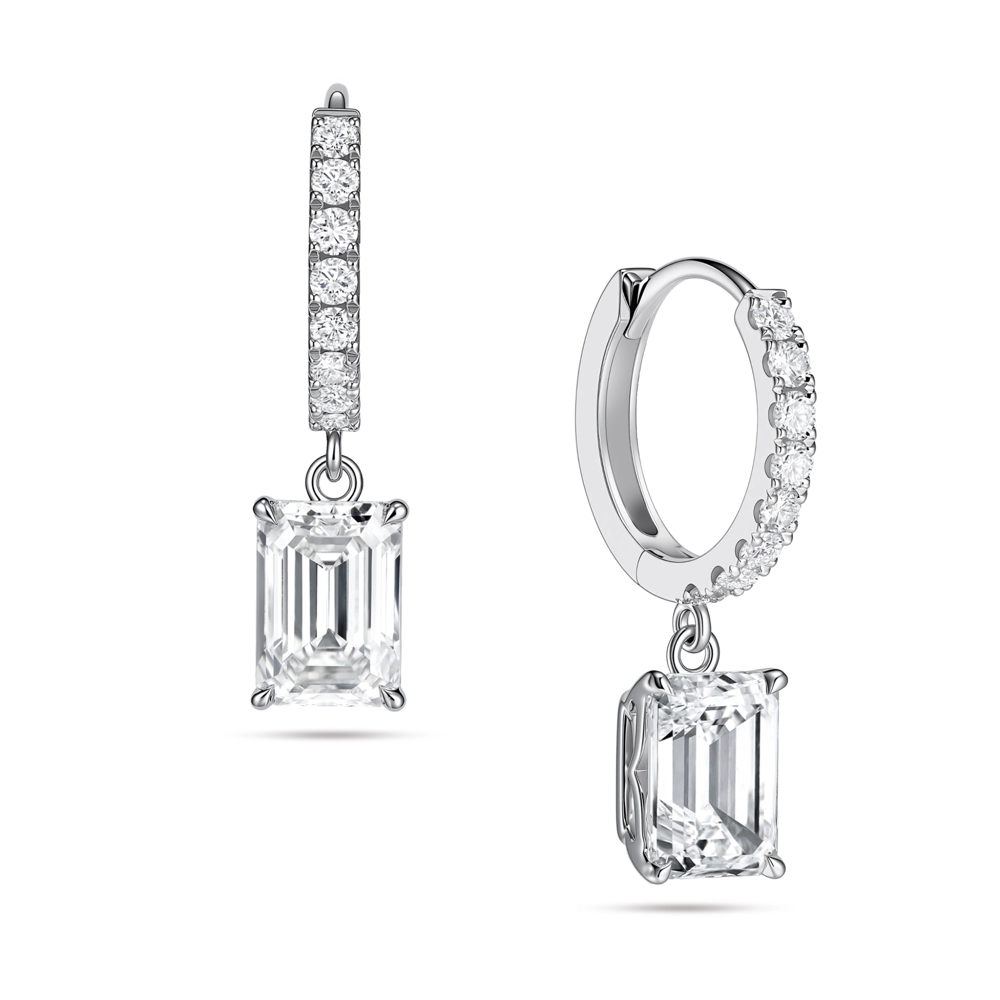 Angled view of the J'ENCHANTE JOY emerald drop earrings in 18K white gold. The image showcases a pair of slim pavé hoops and architectural emerald-cut drops, highlighting the signature J-shaped side profile designed to maximize light passing through for enhanced step-cut clarity.