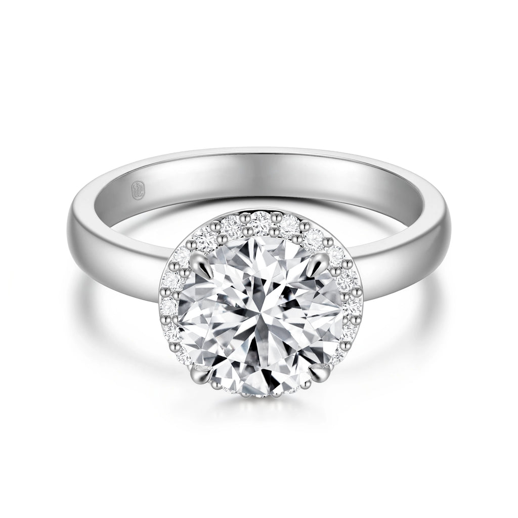 Top view of the J'ENCHANTE JOY halo solitaire diamond ring in 18K white gold, highlighting the brilliant center stone perfectly framed by a sparkling diamond halo, balanced by a clean, minimalist band.