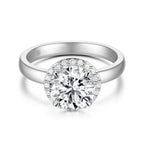Top view of the J'ENCHANTE JOY halo solitaire diamond ring in 18K white gold, highlighting the brilliant center stone perfectly framed by a sparkling diamond halo, balanced by a clean, minimalist band.