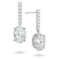 Angled view of the J'ENCHANTE JOY oval bar stud earrings, highlighting the secure stud post and the signature J-shaped side profile of the sculpted setting. This design maximizes side light entry to enhance the clarity and dimension of the oval diamond drop.