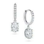 Angled view of the J'ENCHANTE JOY oval drop earrings in 18K white gold. The image showcases a pair of slim pavé hoops and graceful oval-cut drops, highlighting the signature J-shaped side profile designed to maximize side light entry for enhanced diamond clarity and dimension.