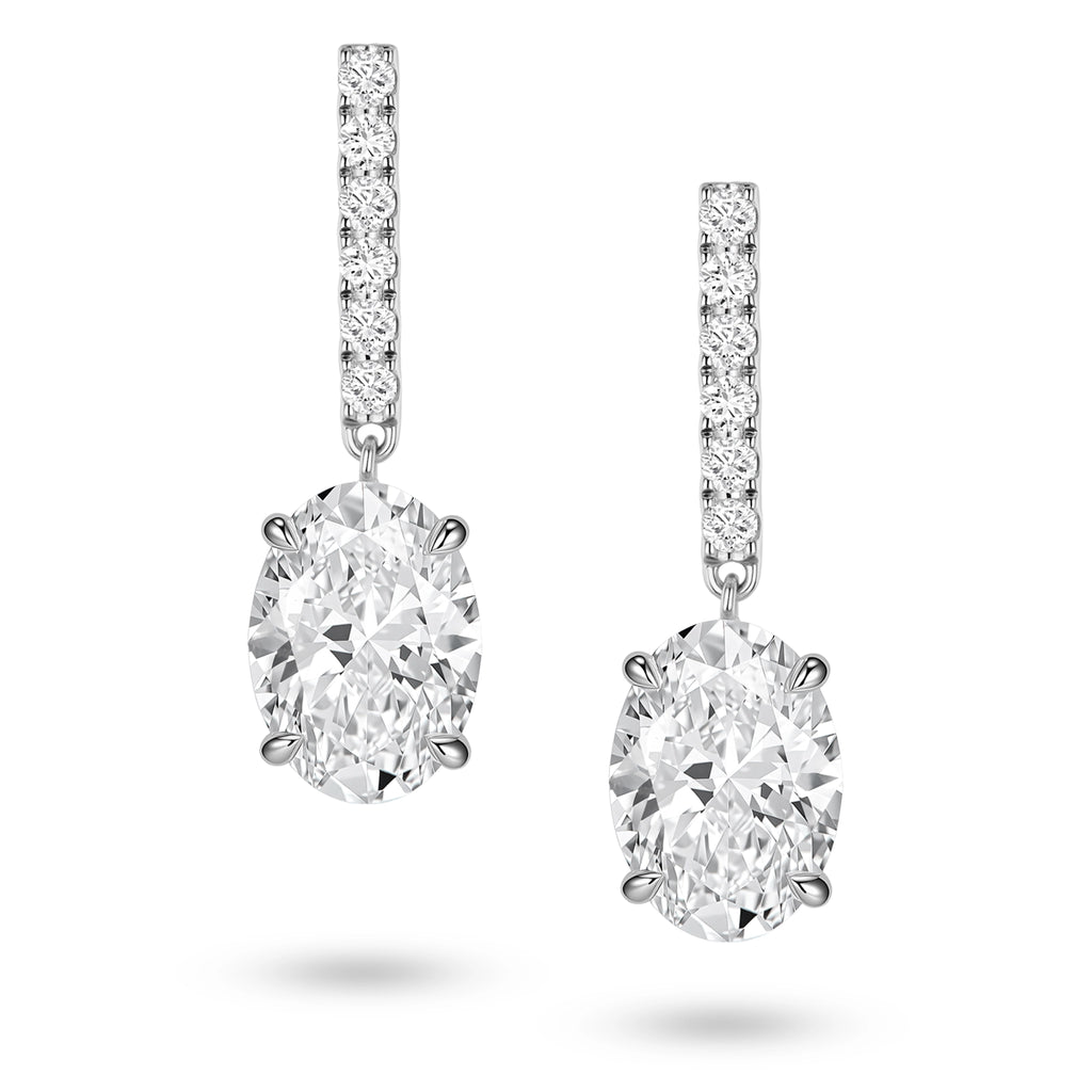 Front view of the J'ENCHANTE JOY oval bar stud earrings, featuring slim vertical bars pavé-set with 12 diamonds (0.2 carats) suspending softly contoured oval focal stones, creating a refined contrast of clean lines and graceful curves.