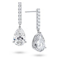 Angled view of the J'ENCHANTE JOY pear bar stud earrings, highlighting the secure stud post and the signature J-shaped side profile of the sculpted setting. This design maximizes side light entry to enhance the clarity and dimension of the pear-shaped drop.