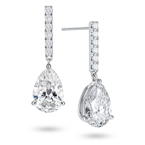 Angled view of the J'ENCHANTE JOY pear bar stud earrings, highlighting the secure stud post and the signature J-shaped side profile of the sculpted setting. This design maximizes side light entry to enhance the clarity and dimension of the pear-shaped drop.