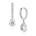 Angled view of the J'ENCHANTE JOY pear drop earrings in 18K white gold. The image showcases a pair of slim pavé hoops and graceful pear-shaped drops, with one earring highlighting the signature J-shaped side profile designed to securely support the diamond while maximizing side light entry for enhanced dimension.
