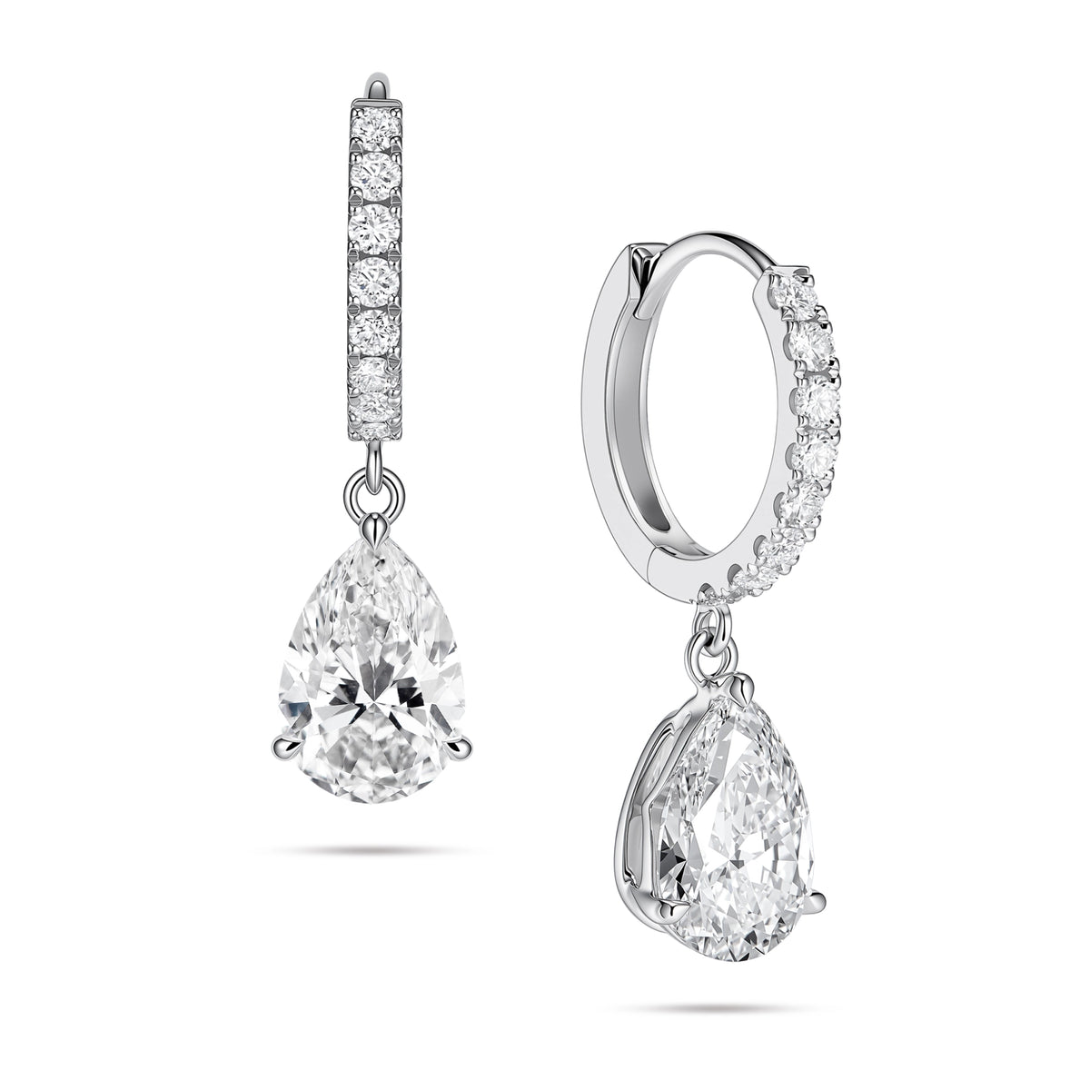 Angled view of the J'ENCHANTE JOY pear drop earrings in 18K white gold. The image showcases a pair of slim pavé hoops and graceful pear-shaped drops, with one earring highlighting the signature J-shaped side profile designed to securely support the diamond while maximizing side light entry for enhanced dimension.