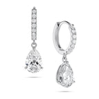 Angled view of the J'ENCHANTE JOY pear drop earrings in 18K white gold. The image showcases a pair of slim pavé hoops and graceful pear-shaped drops, with one earring highlighting the signature J-shaped side profile designed to securely support the diamond while maximizing side light entry for enhanced dimension.