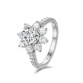 Angled view of the J'ENCHANTE LIFE Full Bloom sunflower diamond ring. The image highlights the elevated center setting that lifts the 1-carat focal diamond, allowing light to flow freely through the floral halo and pavé-set band for enhanced brilliance and striking depth.