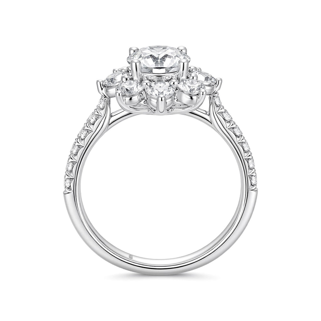 Upright profile view of the J'ENCHANTE LIFE Full Bloom diamond ring. This perspective reveals the intricate architectural support beneath the sunflower halo and its seamless transition into the pavé-set band, beautifully reflecting the collection's "center of our world" philosophy.