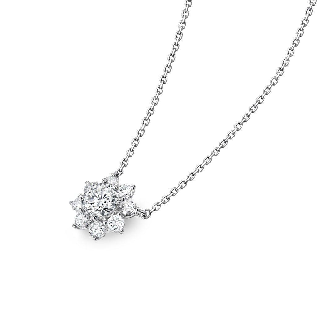Angled view of the J'ENCHANTE LIFE Sunlit Bloom diamond necklace. Inspired by the sunflower, the design features a brilliant round center diamond elevated and framed by a radiant halo of 8 surrounding stones. This refined layered setting beautifully enhances light and dimension, bringing the floral motif to life with strength and presence.