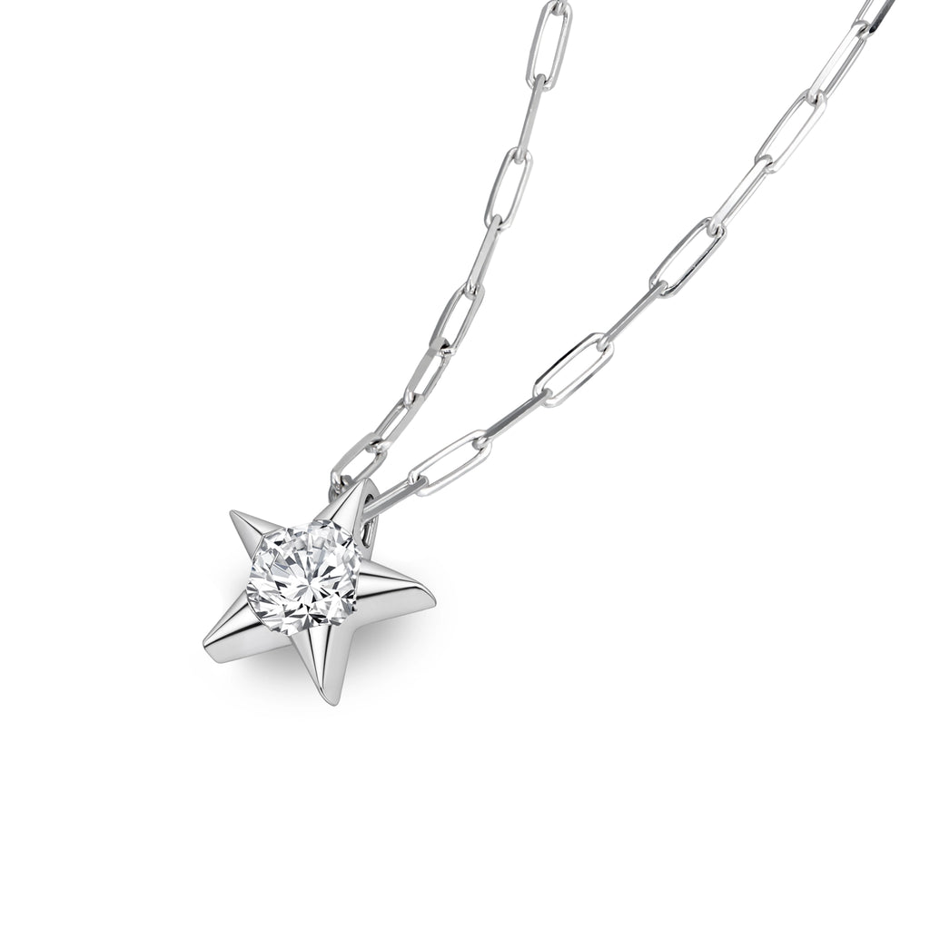 Angled view of the J'ENCHANTE LUCK 0.5ct diamond star necklace in 18K white gold. The perspective highlights the three-dimensional, sculptural depth of the star setting and the brilliant light return of the center diamond, perfectly complementing the textured, modern paperclip chain.