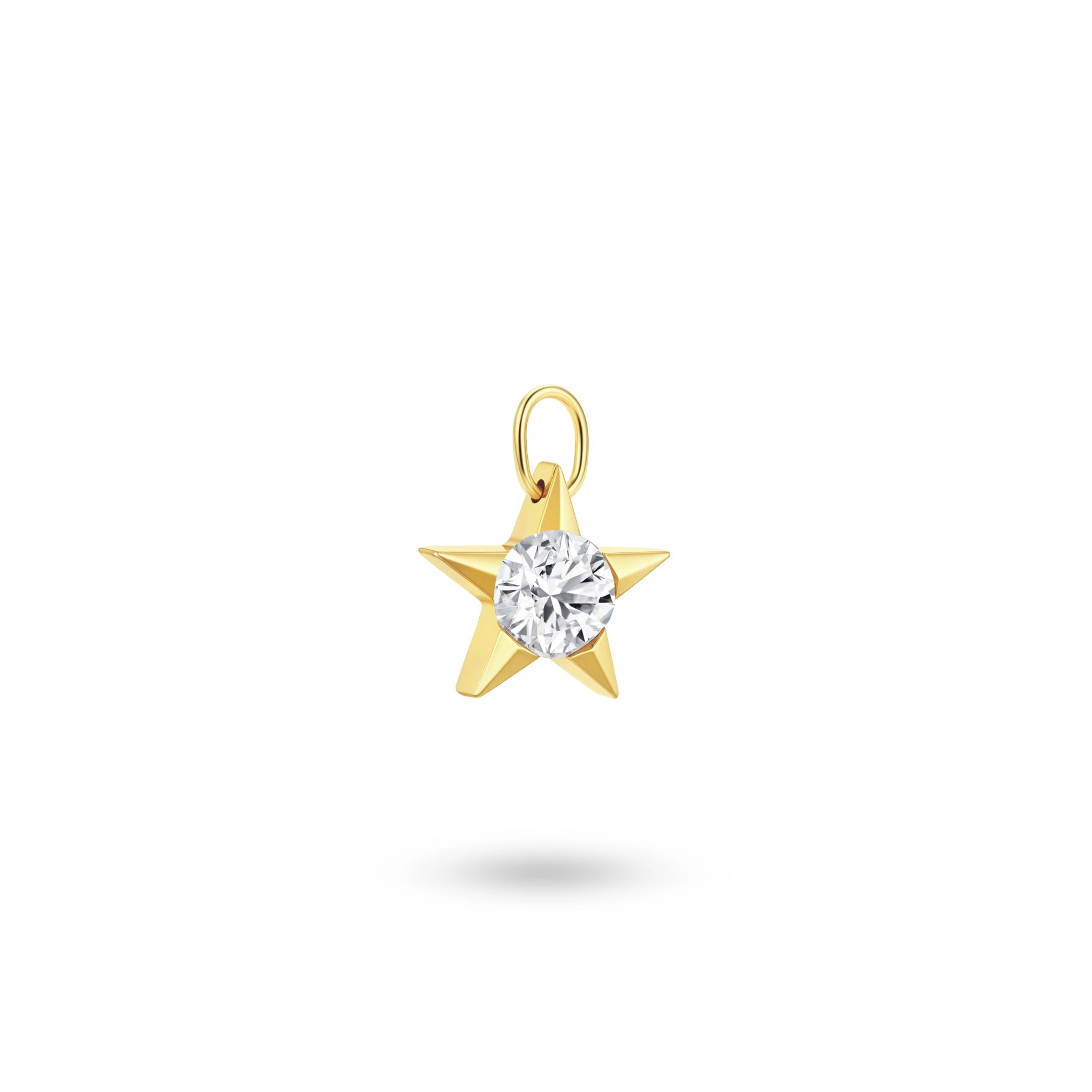 Angled view of the J'ENCHANTE 18k gold star diamond pendant, highlighting the dimensional facets, delicate prongs, and the solid gold top loop.