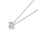 Angled view of the J'ENCHANTE ONE cushion diamond necklace, highlighting the signature J-setting. The elegant architectural curve cradles and elevates the cushion-cut stone, maximizing light return from every facet. A pure expression of form where simplicity becomes a statement.