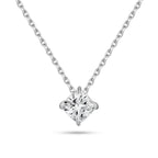 Front view of the J'ENCHANTE ONE cushion-cut diamond solitaire necklace. Suspended on a white gold chain, the brilliant cushion diamond is uniquely kite-set (compass set) to create a striking geometric silhouette. The refined single-stone design allows light to flow naturally, emitting a quiet yet confident brilliance.