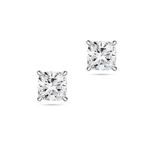Front view of the J'ENCHANTE ONE cushion-cut diamond stud earrings in white gold. The minimalist design features a brilliant cushion-cut diamond on each ear. The soft, rounded corners of the cushion cut offer a pure vision of form, light, and balance for timeless everyday elegance.