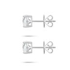 Side profile view of the J'ENCHANTE ONE cushion-cut diamond stud earrings, highlighting the signature J-setting and secure earring backs. The graceful architectural curve cradles and lifts the stone from the side, drawing in light to enhance the depth and brilliance of the diamond.